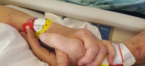 two persons holding hands